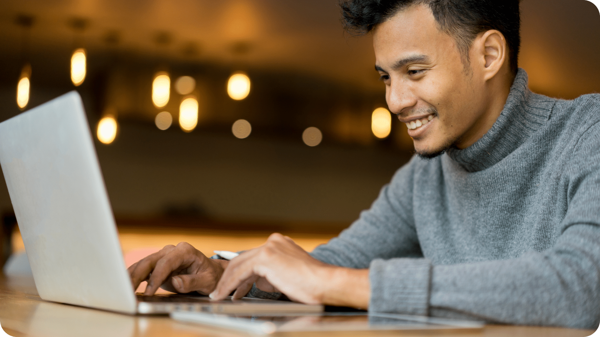 Man smiling at laptop computer