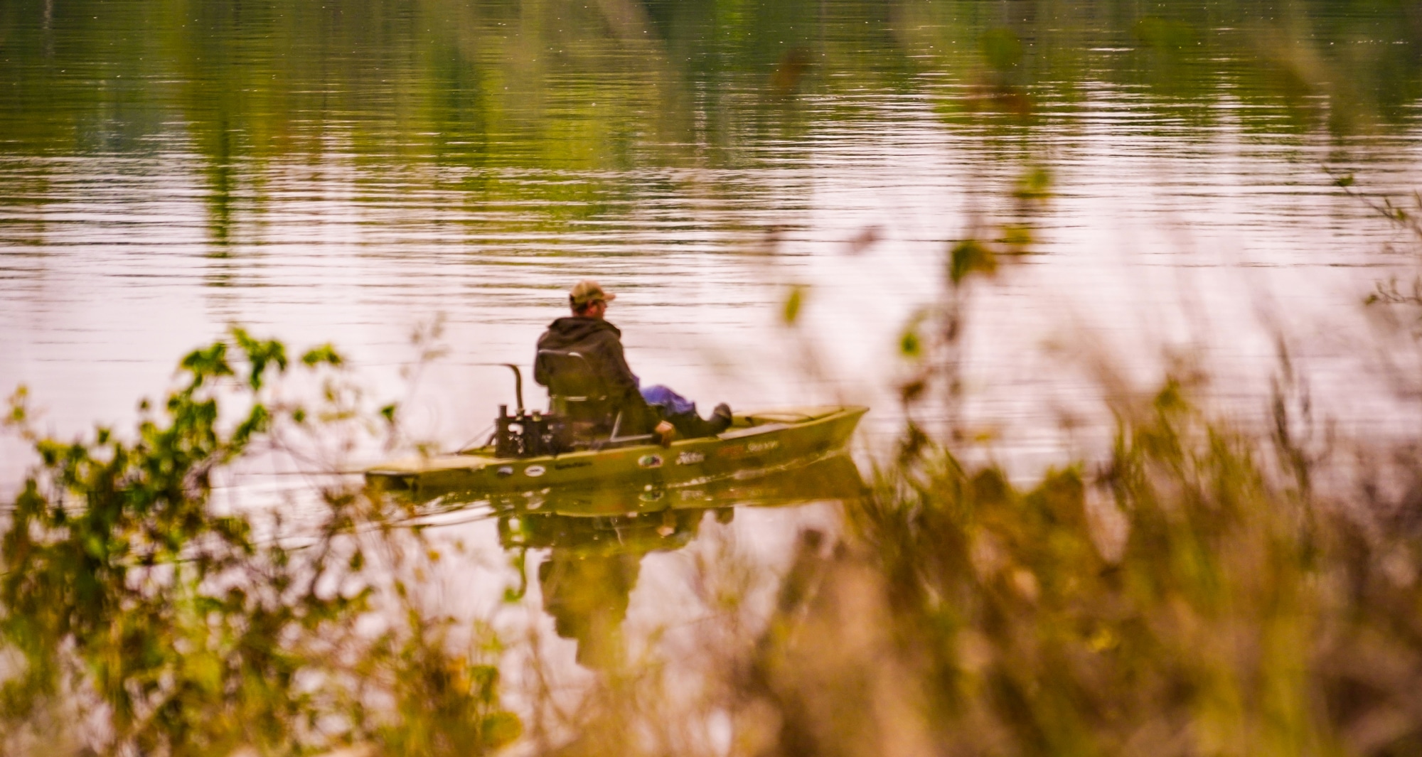 A person in a trolling boat floating down Humphrey's County river.