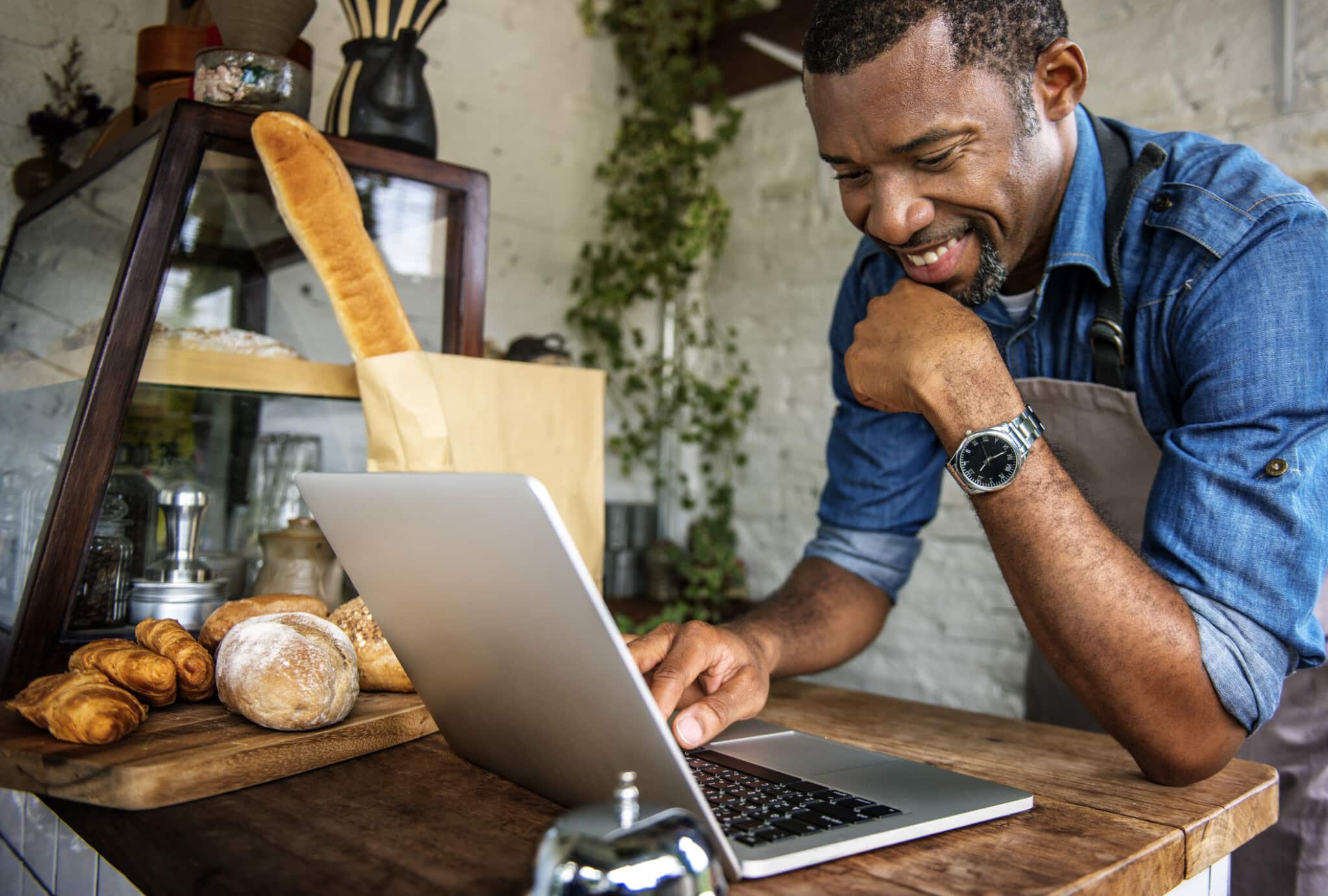 Person leans of laptop reviewing order for their eCommerce shop.