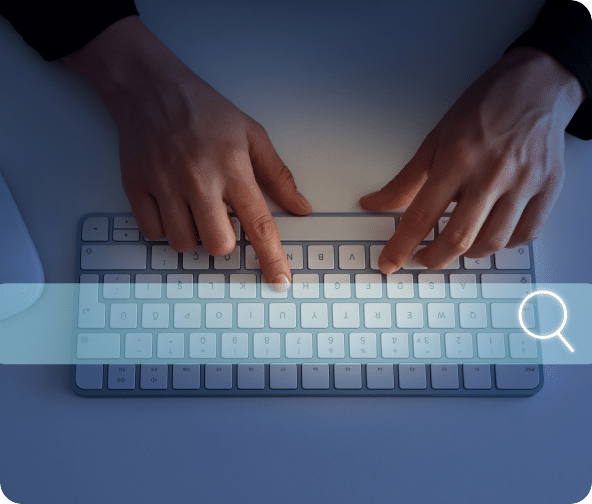 Person types on a keyboard with a search bar across the screen.