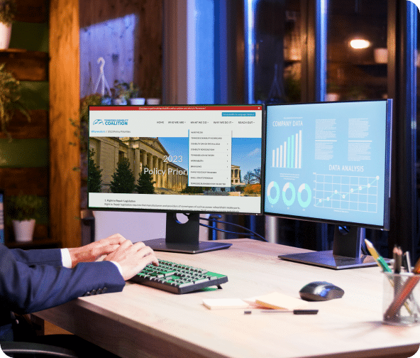 Dual monitors show The Tennessee Disability Coalition website and performance metrics.