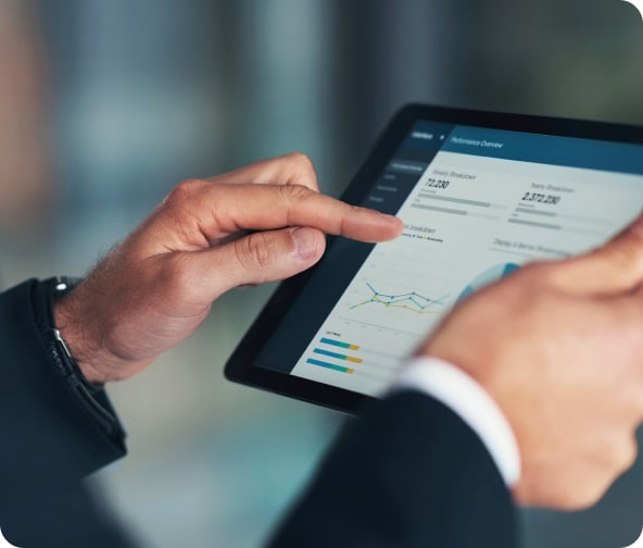 Person reviews their automation reports on a tablet.