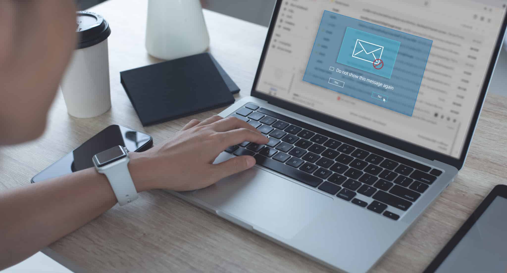 Physician sits at laptop looking at email automation for their medical practice.