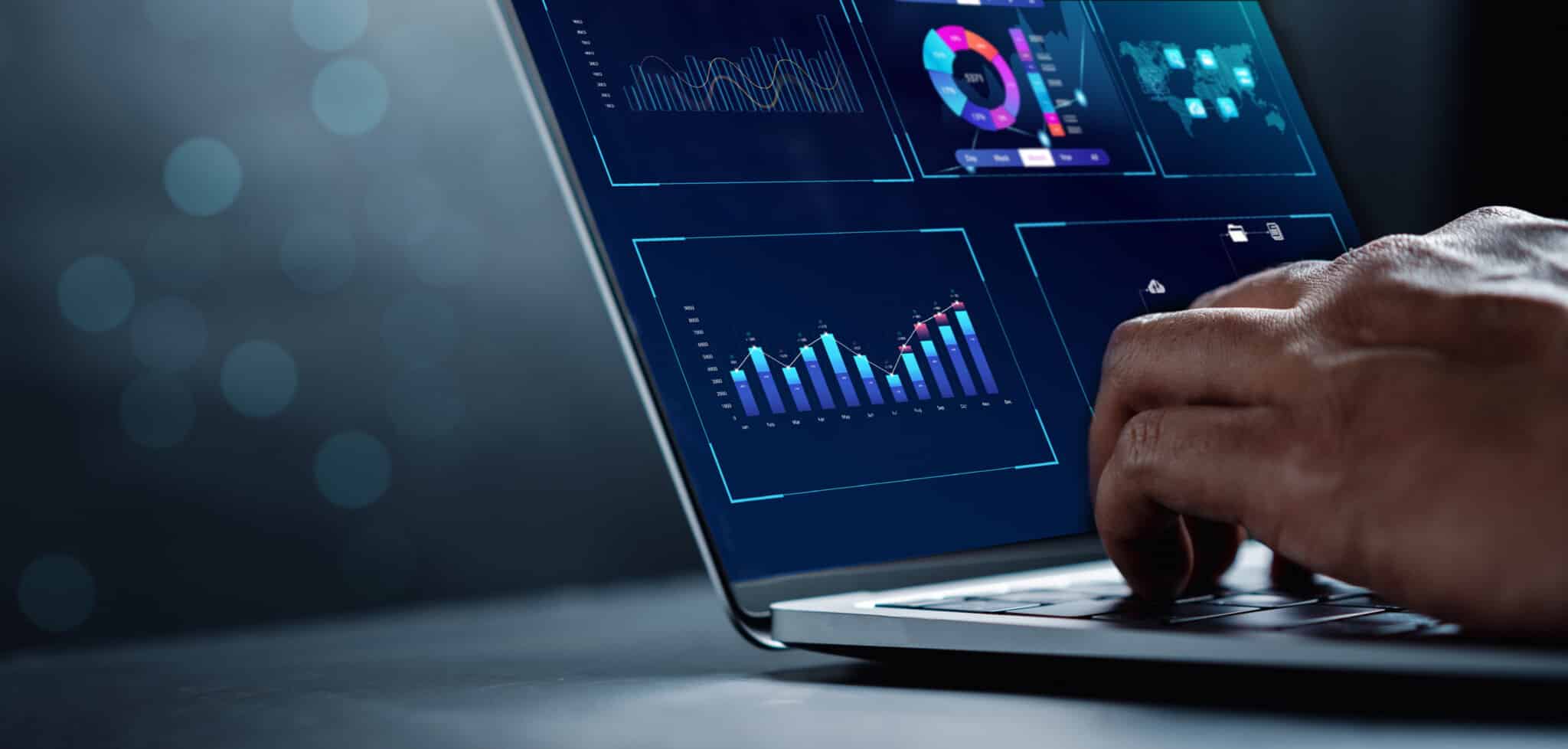 Person looks at reporting data on a laptop with various charts and graphs.