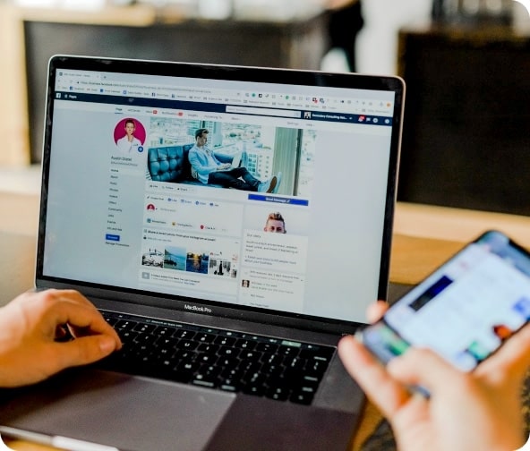 Laptop and mobile view of a tourism social media home page.