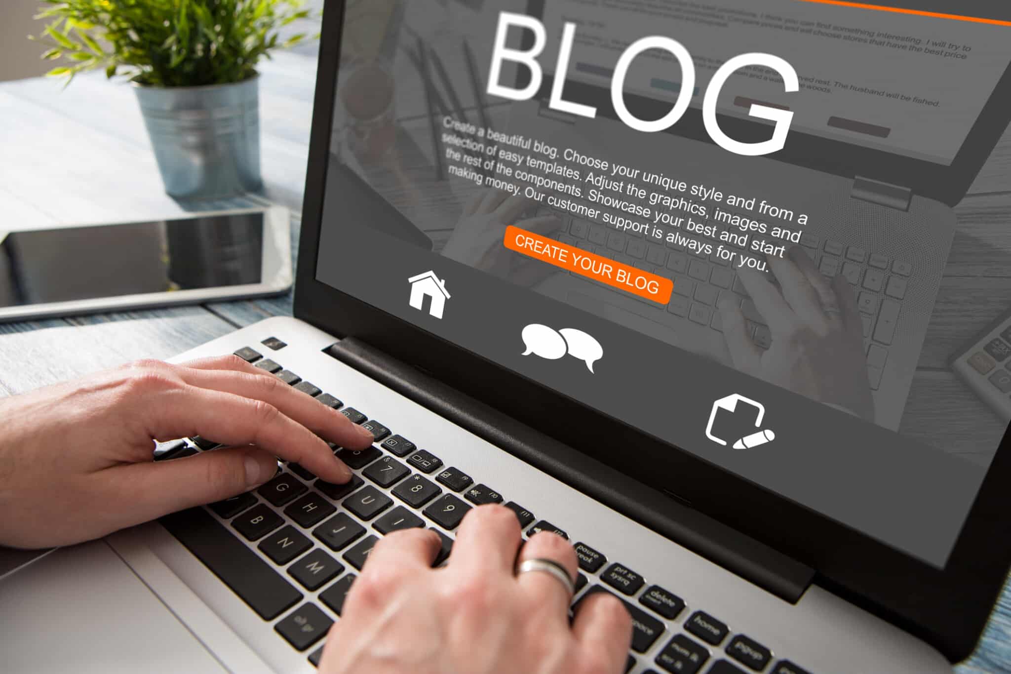A person sits at their laptop preparing to create a blog for their tourism website.