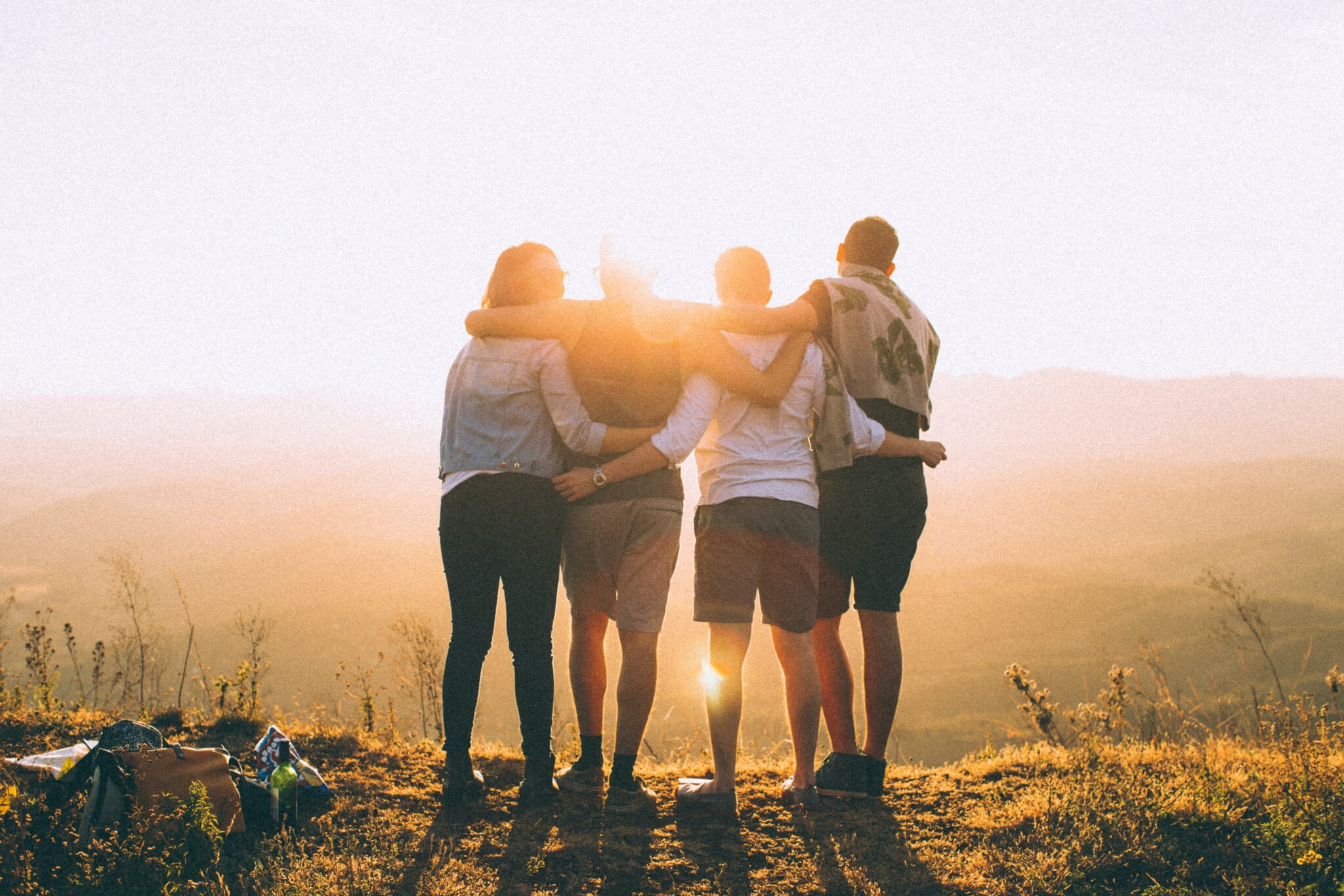 Team of four people watch the sun set on a mountainside in Humphreys County.
