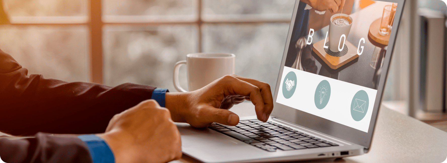 Person sitting at their laptop, looking at a website blog.