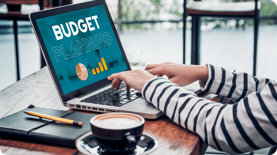 Hands over laptop keyboard with Budget on the screen.