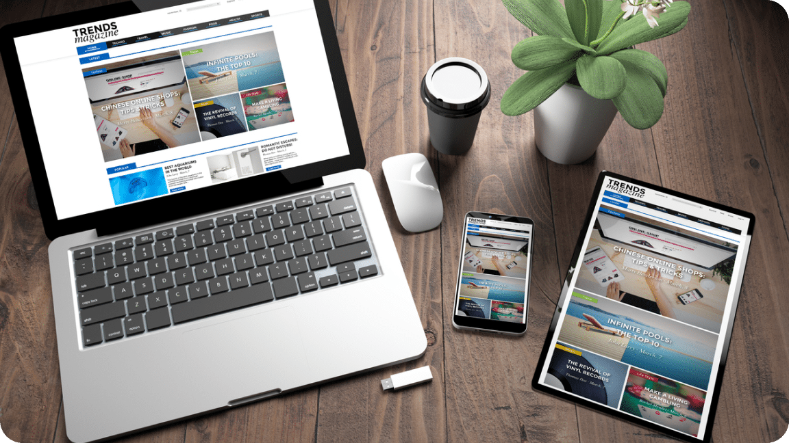 Table, mobile device, and laptop all show the home page for a webpage.