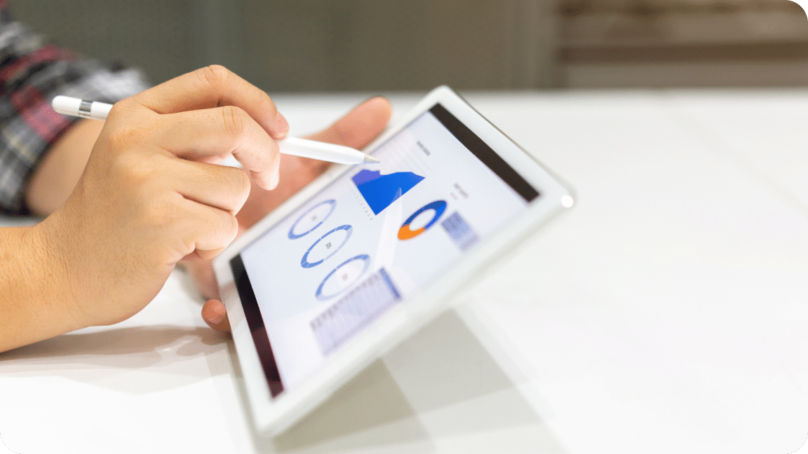 Tablet displays analytics for a website showing various charts and graphs.