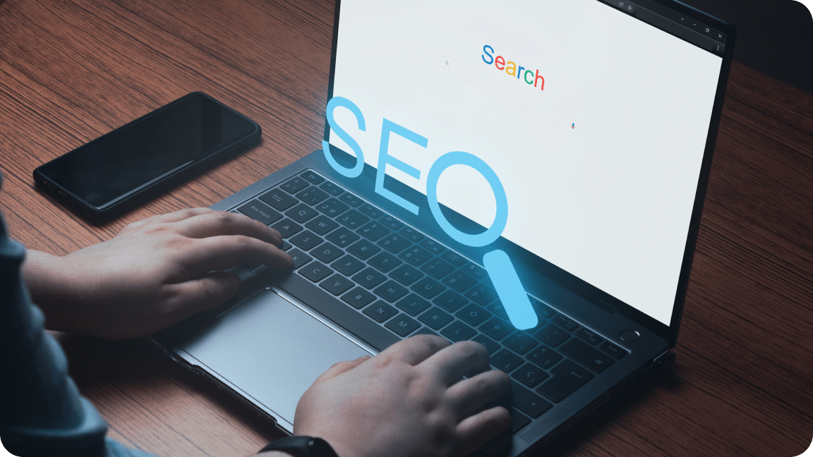 Open laptop to a search display with a holographic blue SEO over the keyboard.