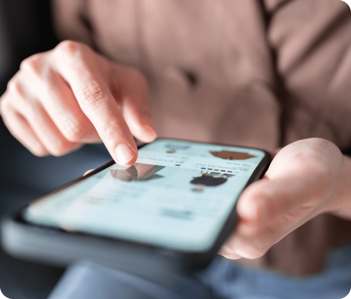 Person shops on their mobile phone, scrolling clothing.