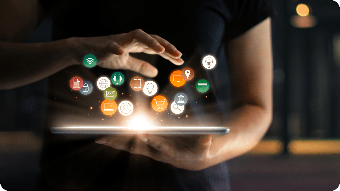 Person holds a tablet flat in their hand with various colored icons for chat, headphones, and other above it.