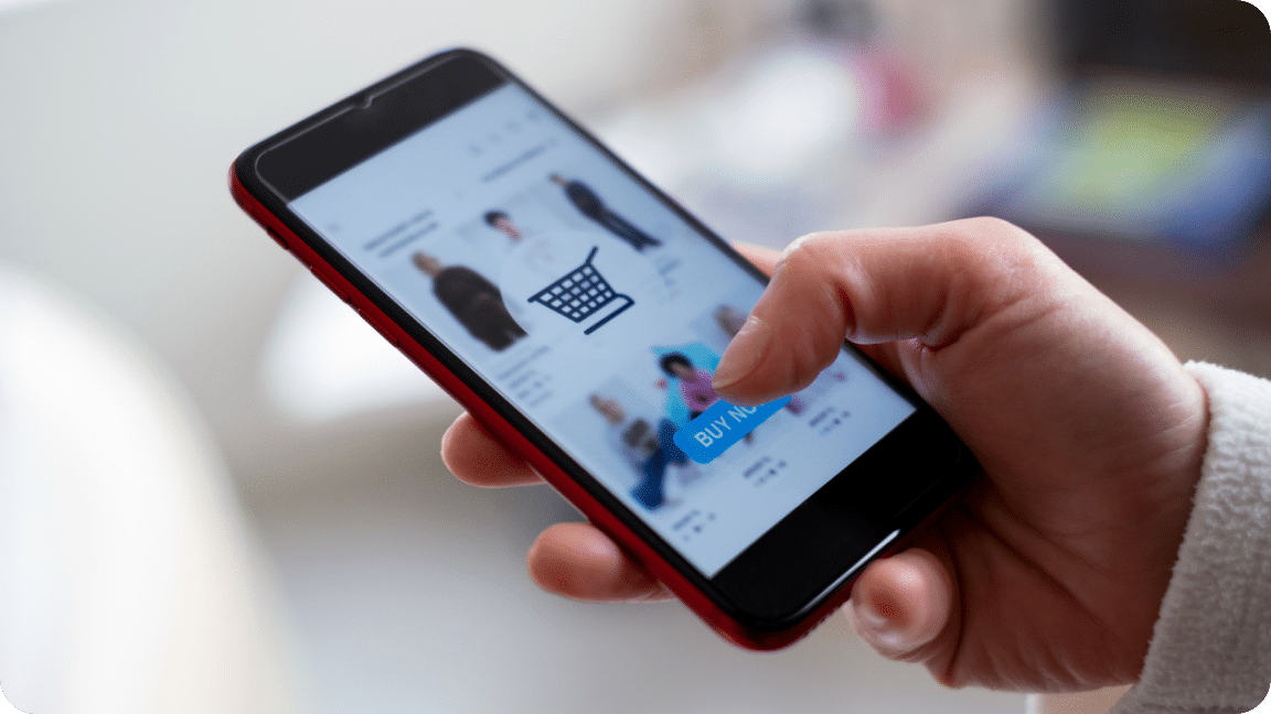 A person scrolls through and eCommerce shop on their mobile phone.