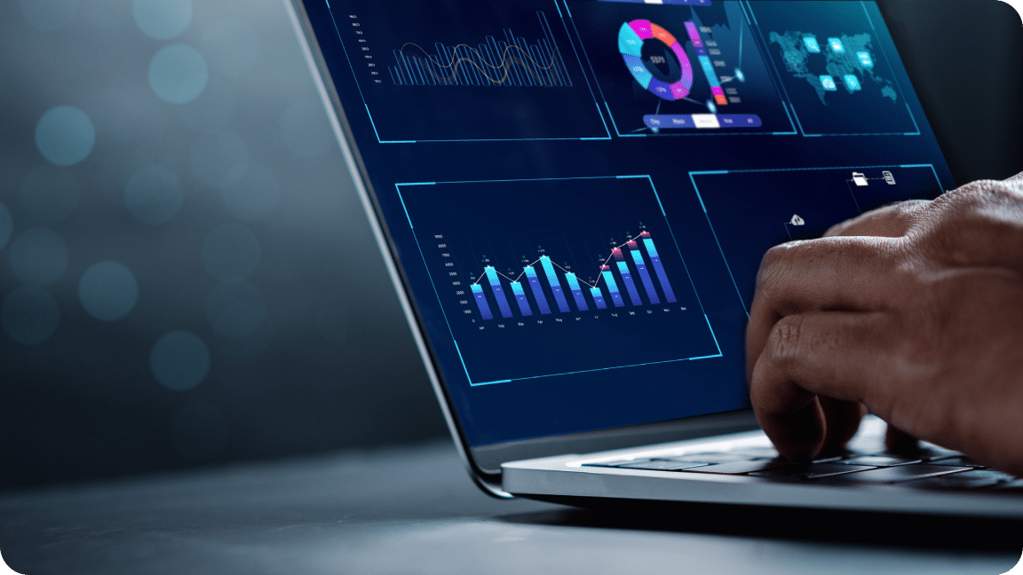 Open laptop reveals colorful charts and graphs reflective of data reporting.
