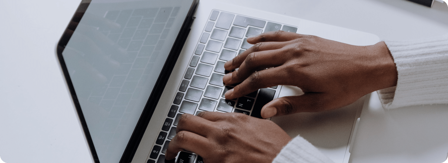 Person types new content our for a website blog on a laptop.