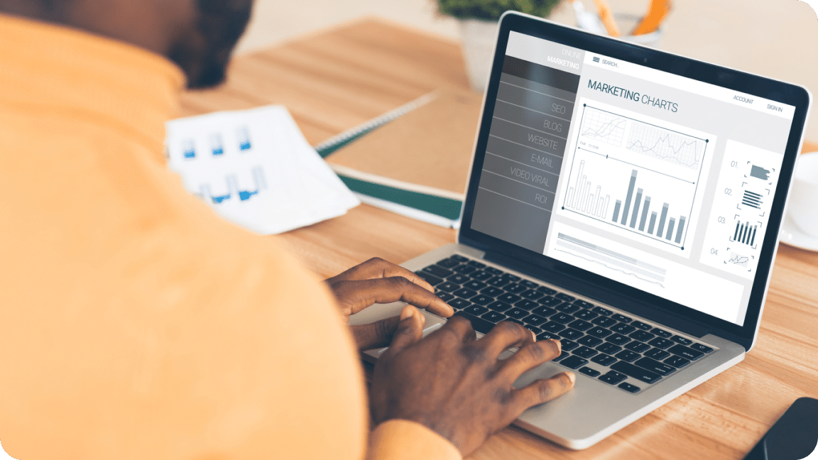 Website growth chart on the screen of a laptop with a person typing on the keyboard.