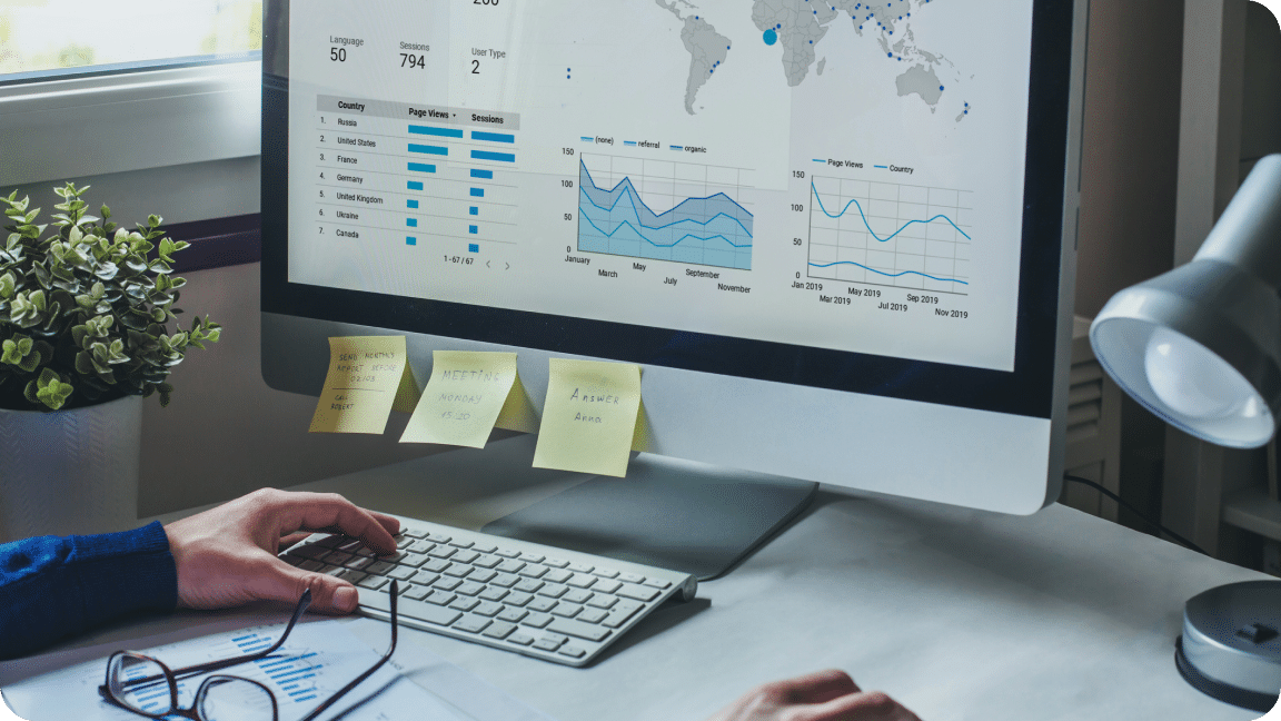 Person sits at their computer, reviewing data and stats for a competitive market analysis.