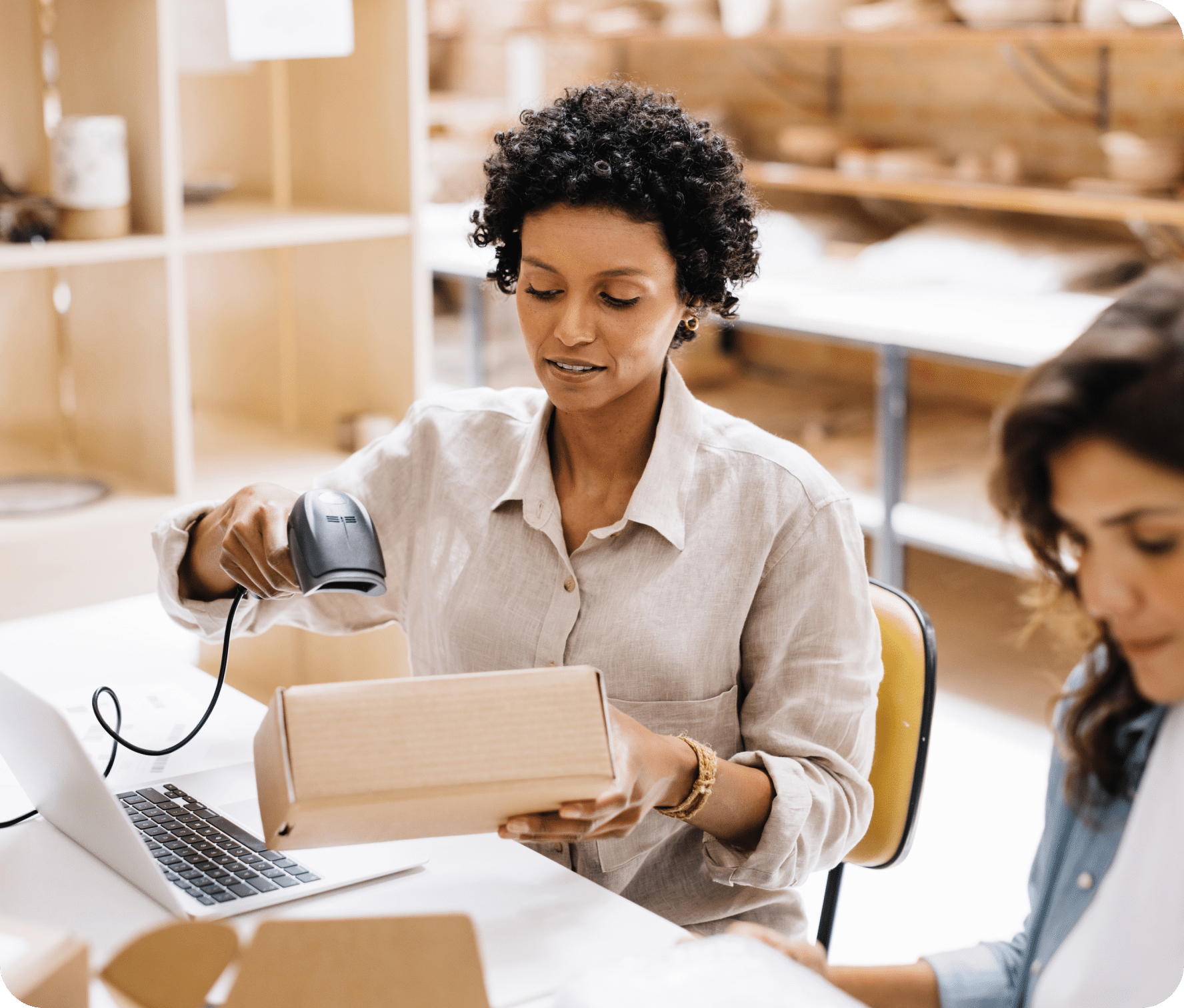 Business owner scans a package ordered online and tracked through their WooCommerce website.