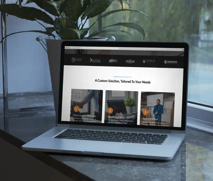 Silver laptop in front of a window with a webpage opened presenting ROI-focused marketing, and customized solutions provided by Plan Left.